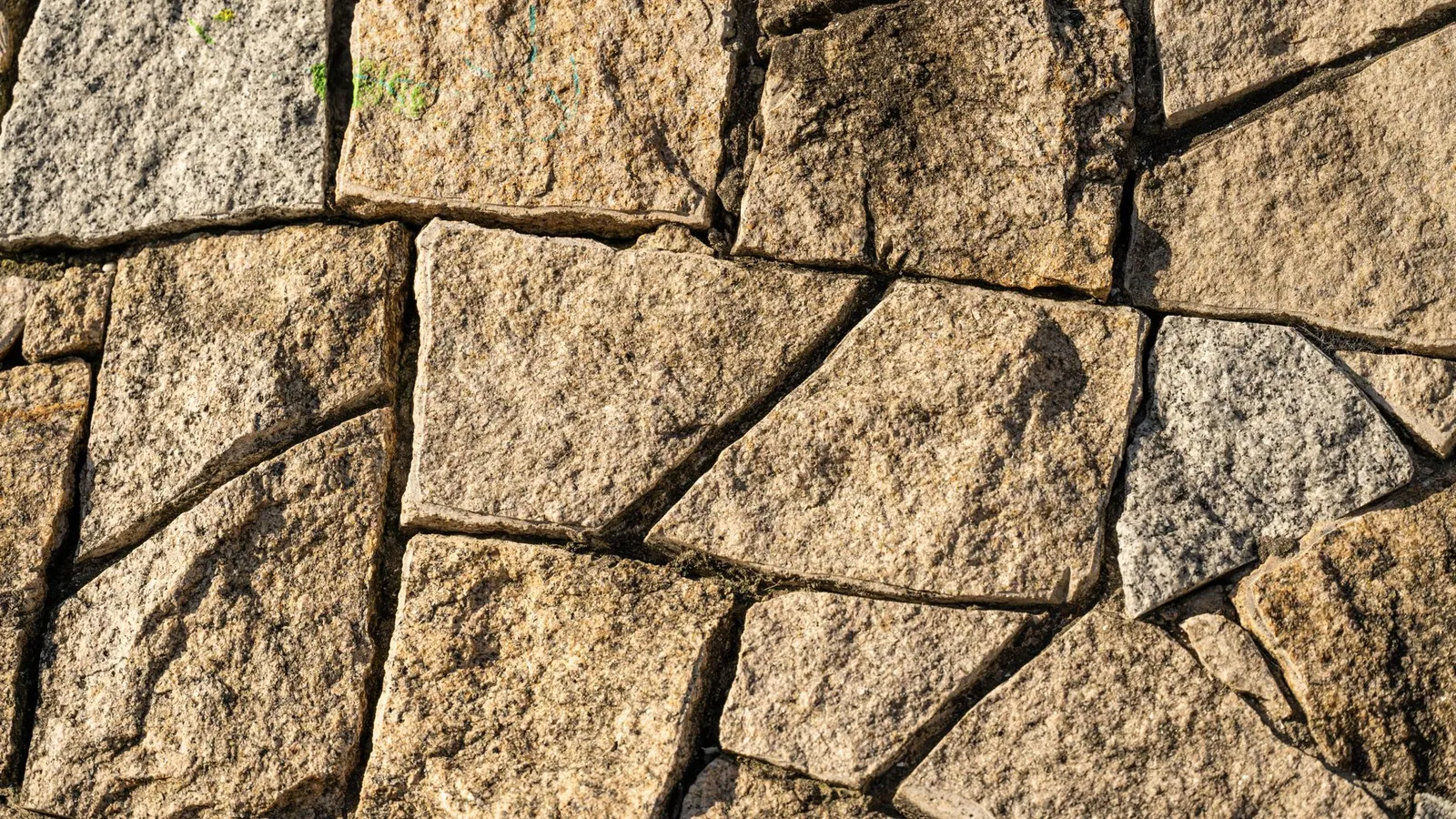 Segmental block retaining wall with proper drainage holding a terraced slope in a residential yard